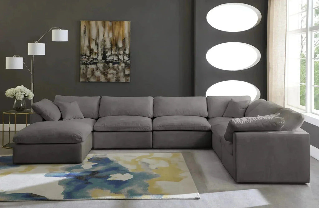 Modern cream footstool and large 6-seater grey modular corner sofa in a stylish living room