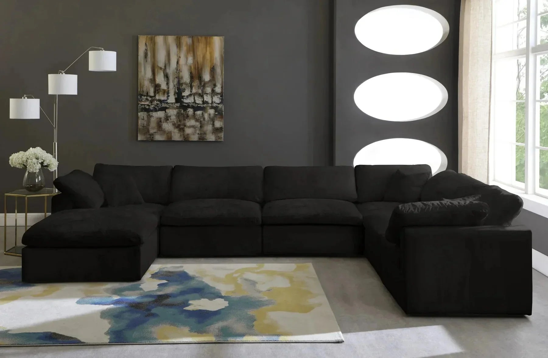 Modern black 6-seater modular corner sofa with footstool in contemporary living room