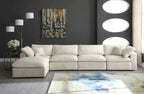 Cream modular corner sofa with chaise in modern living room, dark walls, and abstract rug