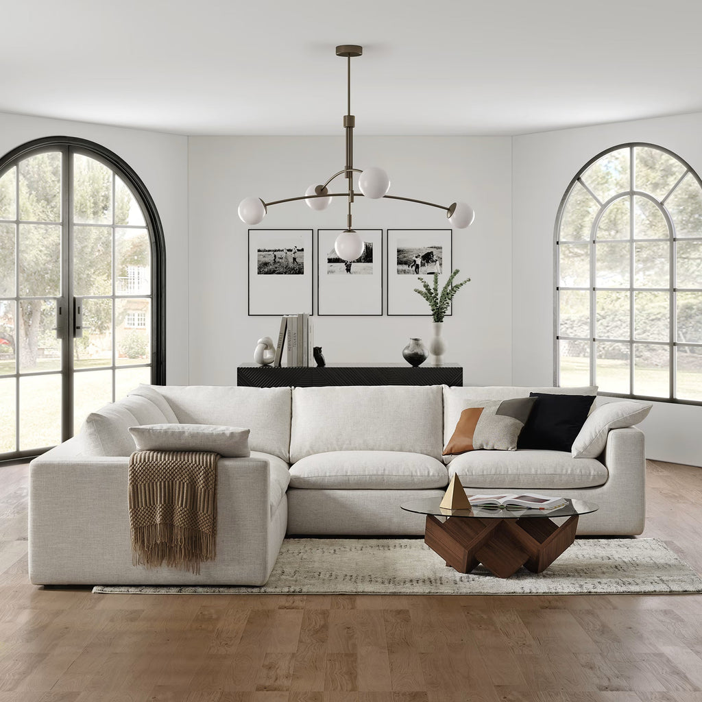 Cream modular 5-seater corner sofa in modern living room with large arched windows