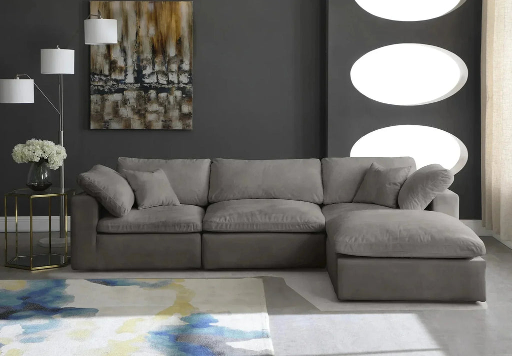 Modern living room with a grey modular corner sofa, abstract rug, and dark accent wall.