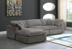 Modern cream modular corner sofa with footstool in a stylish living room