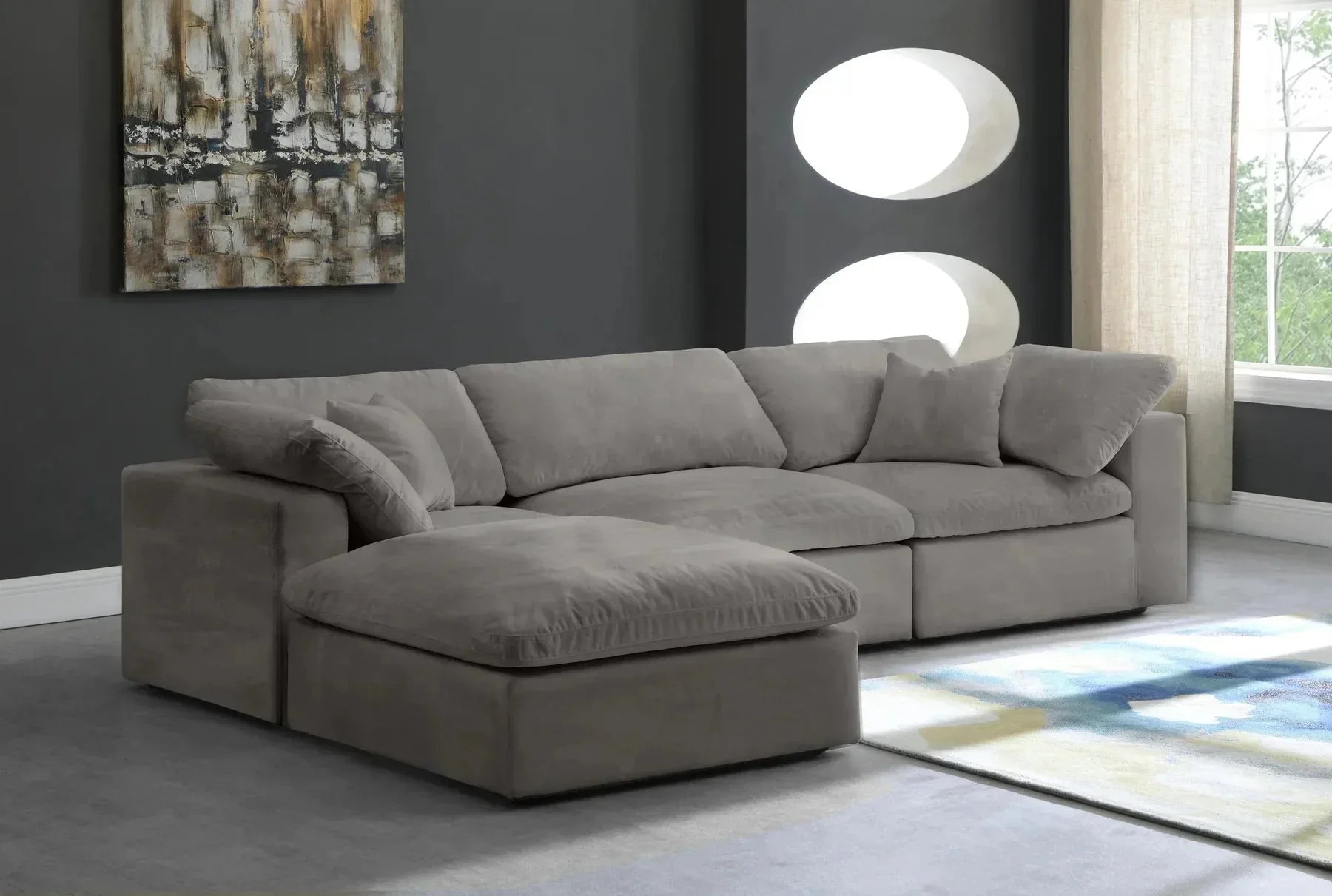 Modern cream modular corner sofa with footstool in a stylish living room