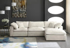 Cream modular corner sofa with chaise lounge in modern living room, abstract art, floor lamp, and geometric side table