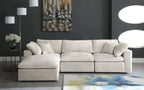 Cream modular sectional sofa with plush cushions in modern living room with dark walls and abstract decor