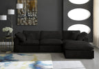 Modern black modular sofa with chaise in stylish living room, abstract art, and large rug