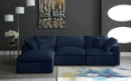 Modern living room with a navy blue modular corner sofa, abstract rug, and wall art.