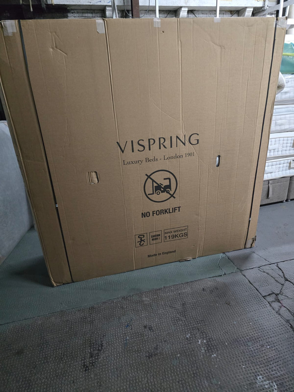 Large cardboard box labeled Vispring luxury beds, with no forklift and max weight symbols.