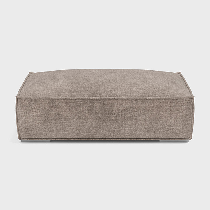 Taupe fabric double corner footstool on white background, modern rectangular design