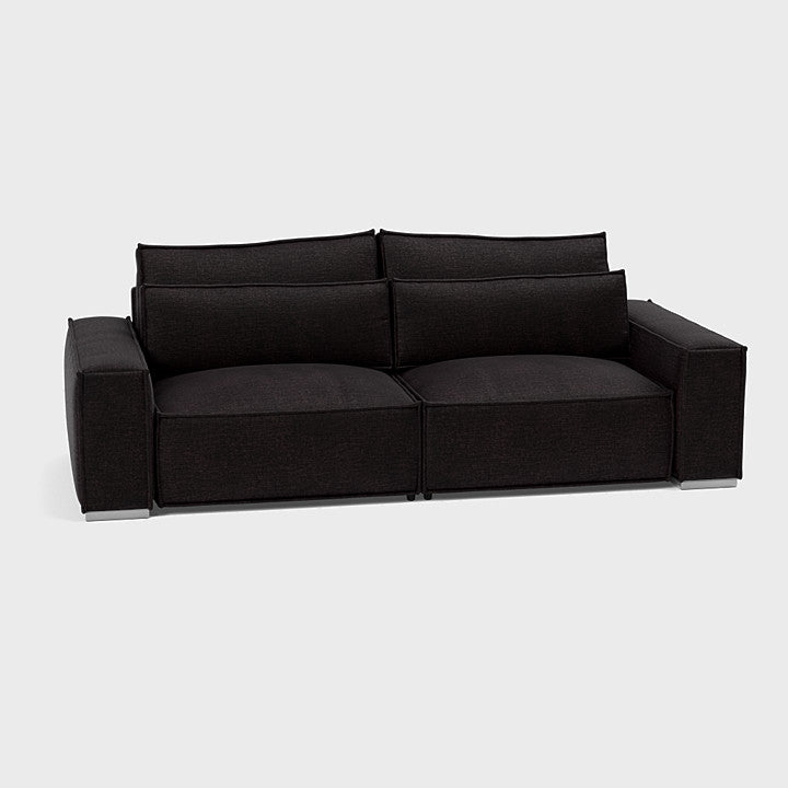 Modern dark grey three-seater sofa with wide arms and plush back cushions on white background