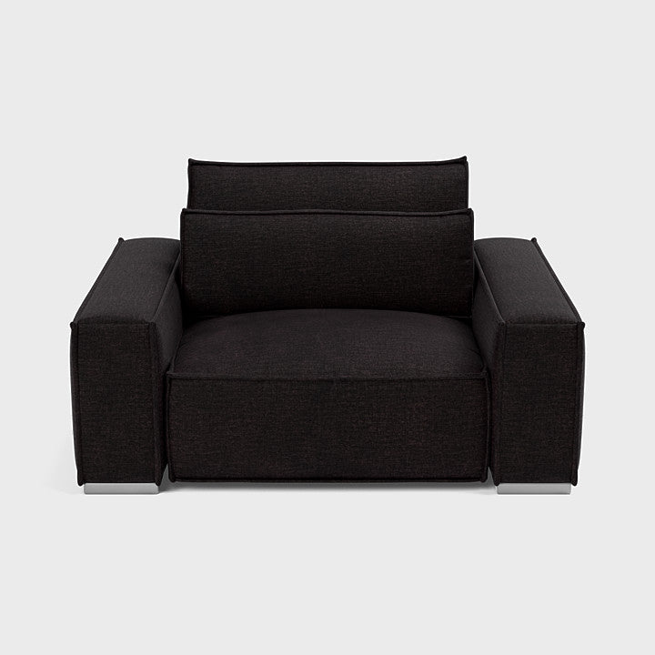 Modern black fabric armchair with wide seat and armrests on a white background