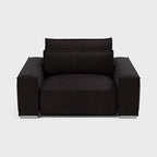 Modern black fabric armchair with wide seat and armrests on a white background
