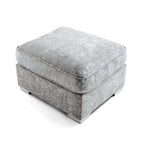 Cream upholstered square footstool with plush cushion and modern low feet on white background