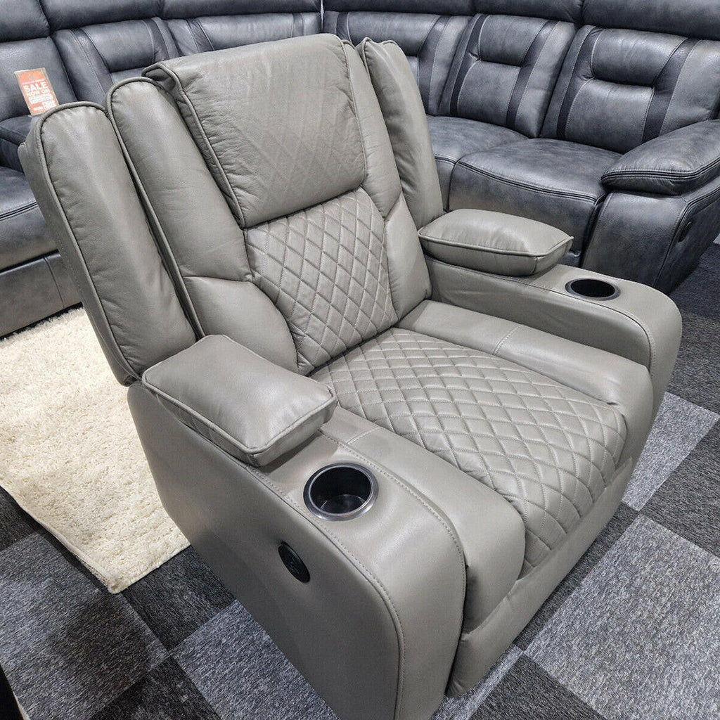 Grey electric recliner armchair with quilted seat, cup holders, and padded armrests