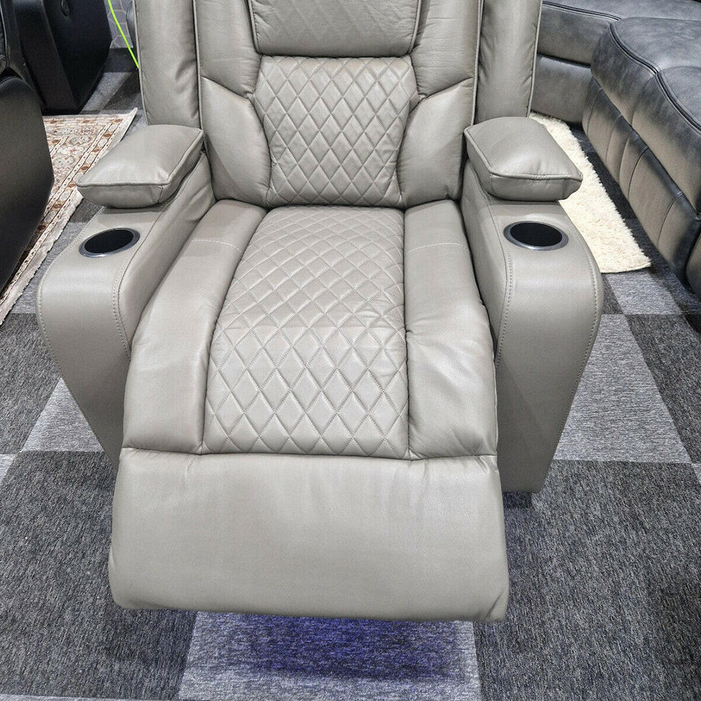 Grey electric recliner armchair with diamond-stitched upholstery and cup holders