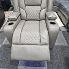 Grey electric recliner armchair with diamond-stitched upholstery and cup holders