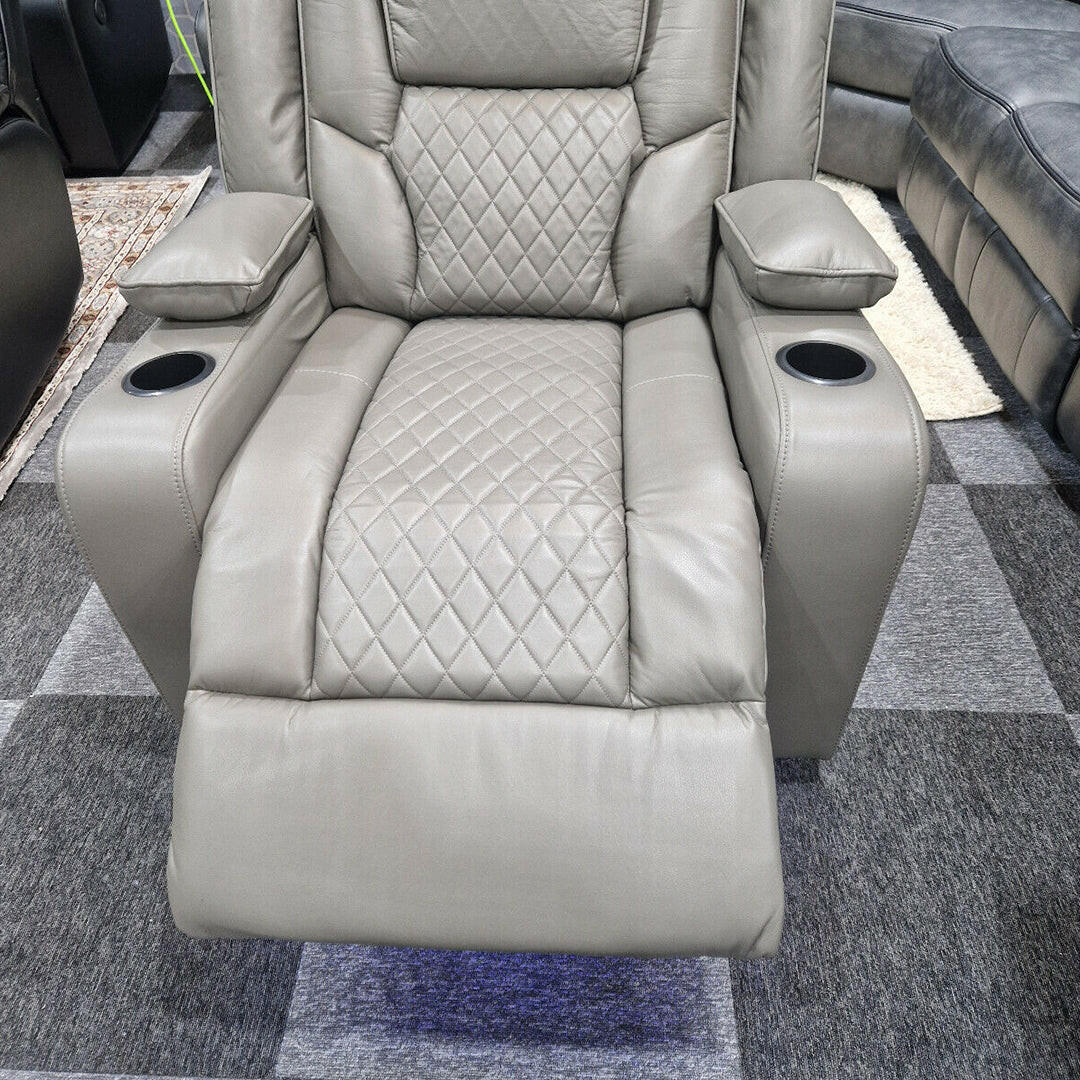 Grey electric recliner armchair with diamond-stitched upholstery and cup holders