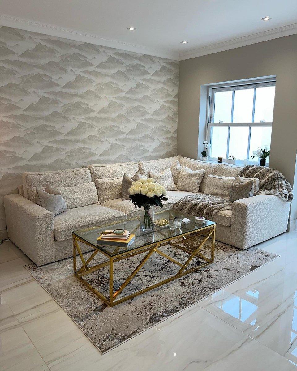 Cream boucle modular corner sofa in elegant living room with gold glass coffee table