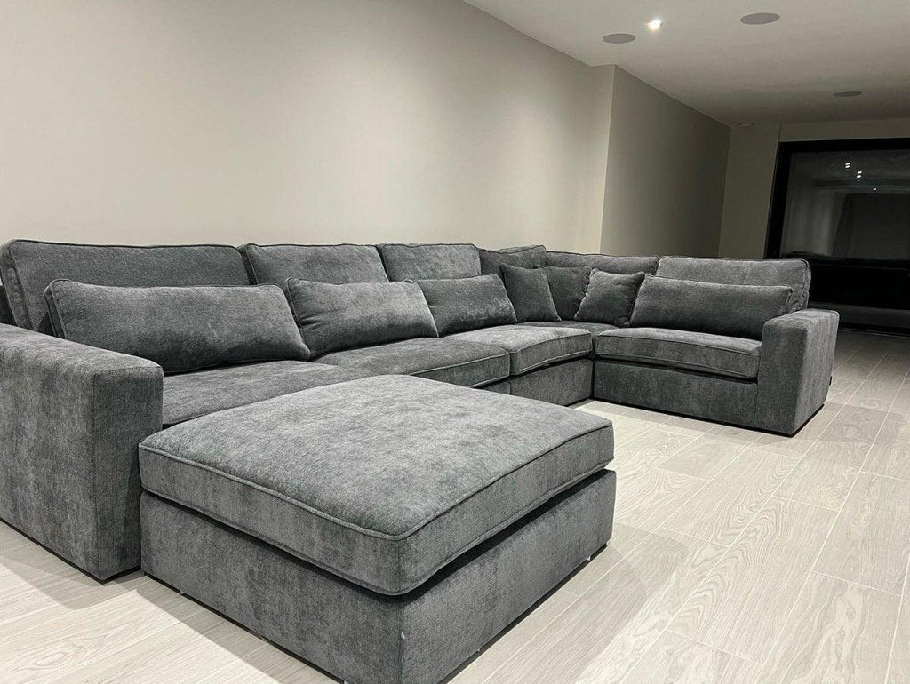 Grey 5-piece modular corner sofa with chaise in a modern living room with light flooring