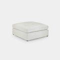 Modern cream boucle footstool with square shape and minimalist design on white background
