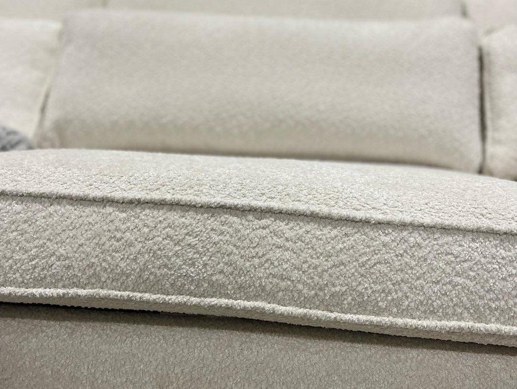 Close-up of cream boucle modular sofa cushion with soft textured upholstery