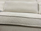 Close-up of cream boucle modular sofa cushion with soft textured upholstery