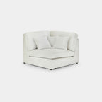 Cream boucle modular corner sofa piece with plush cushions on white background