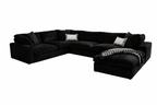 Large black U-shaped modular sofa with footstool, scatter cushions and a houndstooth throw.