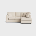 Modern cream right corner sofa with chaise and cushions on light background