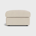 Cream fabric ottoman footstool with clean lines on a white background