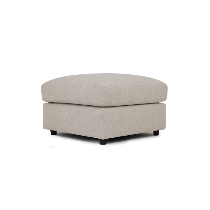 Cream fabric ottoman footstool with cushioned top and low dark feet, modern living room style