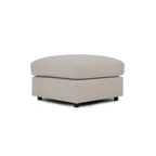 Cream fabric ottoman footstool with cushioned top and low dark feet, modern living room style