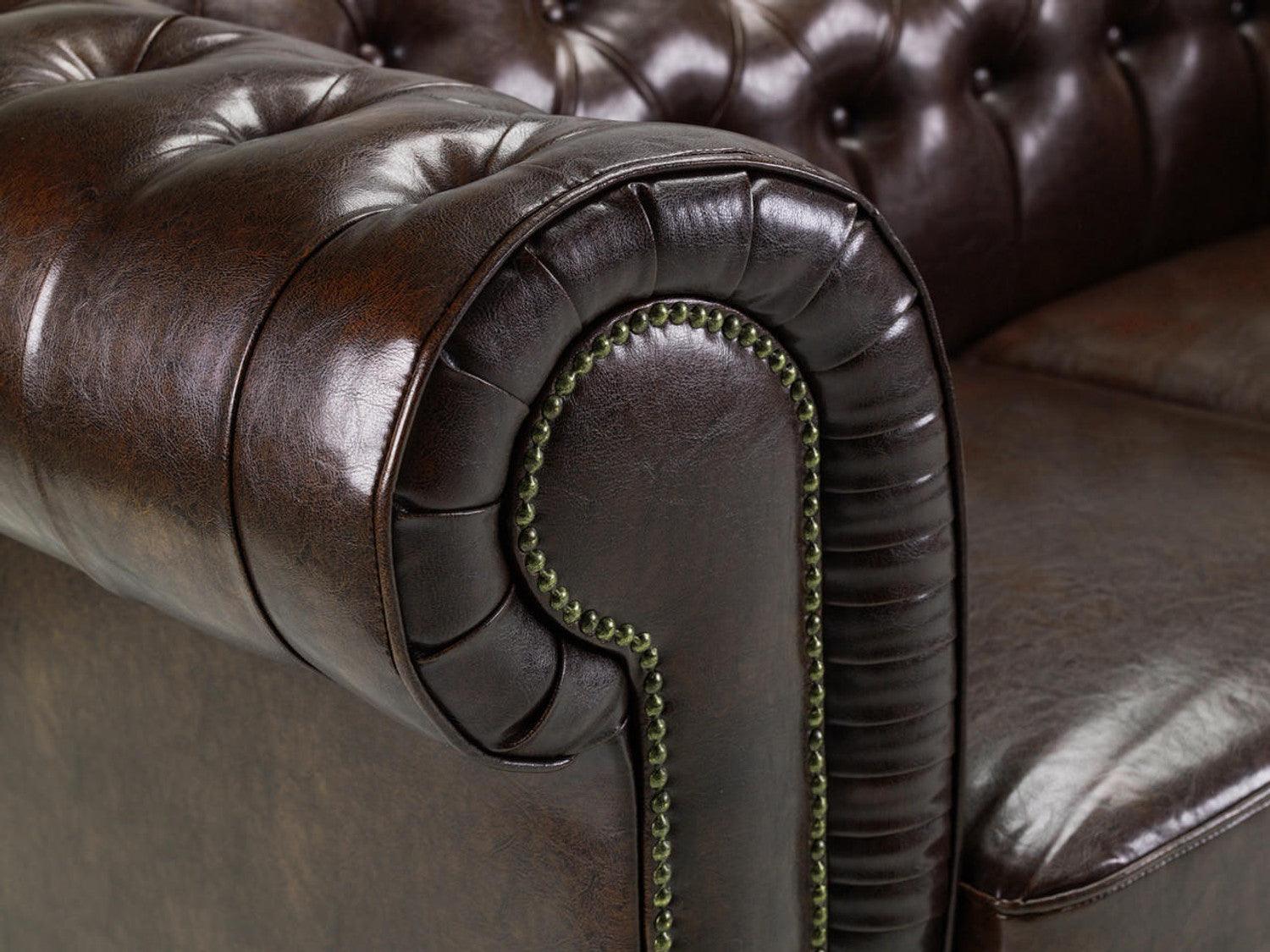 Antique brown Chesterfield leather sofa armrest with button tufted detail