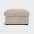 Modern cream fabric ottoman footstool with minimalist design on a white background