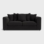 Modern black fabric sofa with plush cushions and rounded arms on a light background