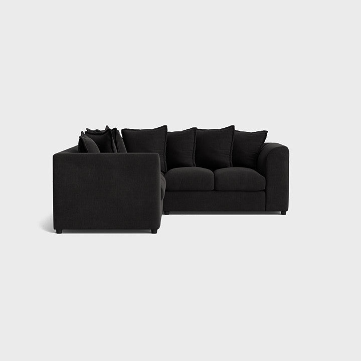 Modern black corner sofa set with deep seats and plush back cushions on white background