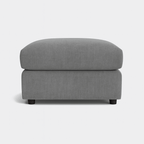 Modern grey fabric ottoman with short black legs, minimalist style, on white background