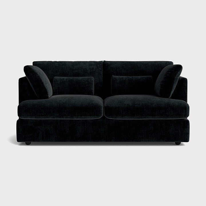 Black chenille two-seater sofa with plush cushions on a white background