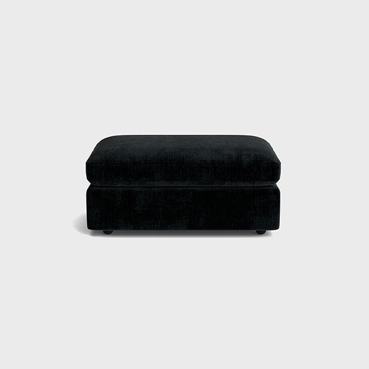 Black chenille ottoman with plush cushion, modern living room furniture, neutral background