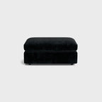 Black chenille ottoman with plush cushion, modern living room furniture, neutral background