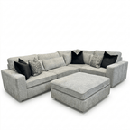 Modern 4-piece ash grey corner sofa with ottoman and black accent pillows
