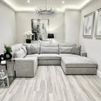 Modern ash grey corner sofa in a contemporary living room with neutral decor and artwork