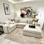 Modern living room with oatmeal fabric 4-piece corner sofa, neutral decor, and plush rug