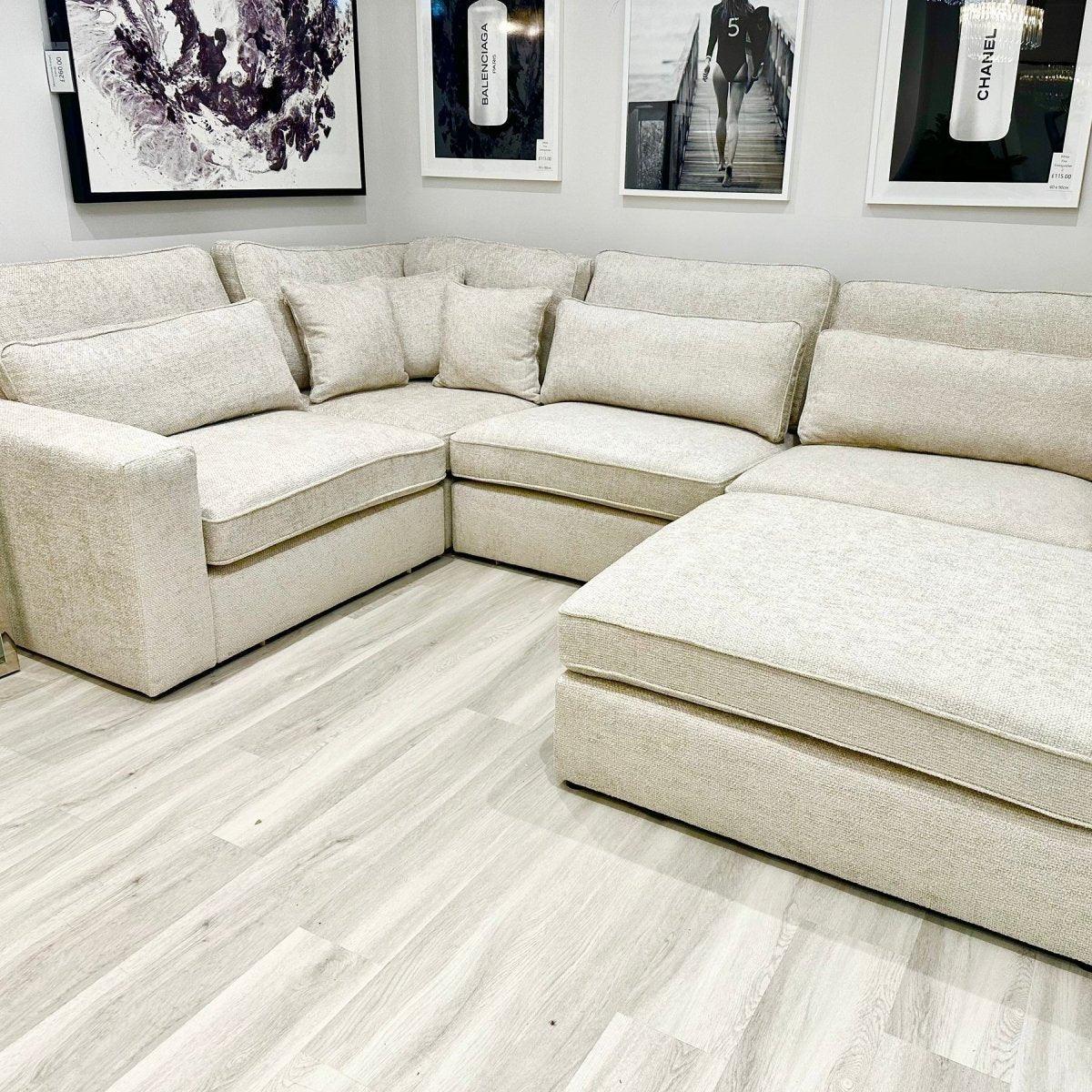 Oatmeal fabric 4-piece corner sofa with chaise in modern living room, light wood flooring