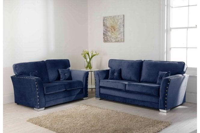 Luxury navy blue velvet 3 and 2 seater sofas with studded arms in modern living room