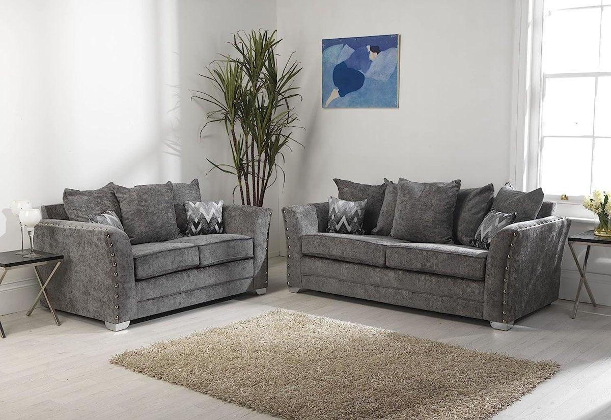 Grey fabric 3 seater and 2 seater sofas in modern living room with decorative cushions