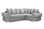 Grey left-facing corner sofa bed with scatterback cushions and rolled arms