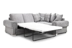 Light grey corner sofa bed with plaid and deer scatter cushions, pull-out mattress extended