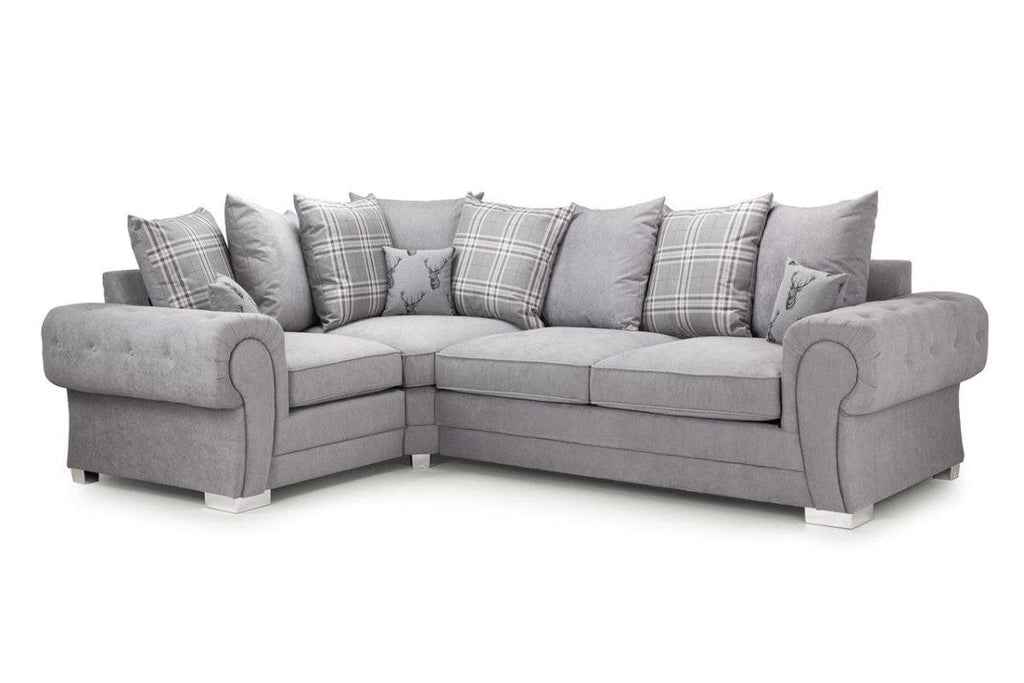 Light grey corner sofa with scatter back cushions and plaid accent pillows