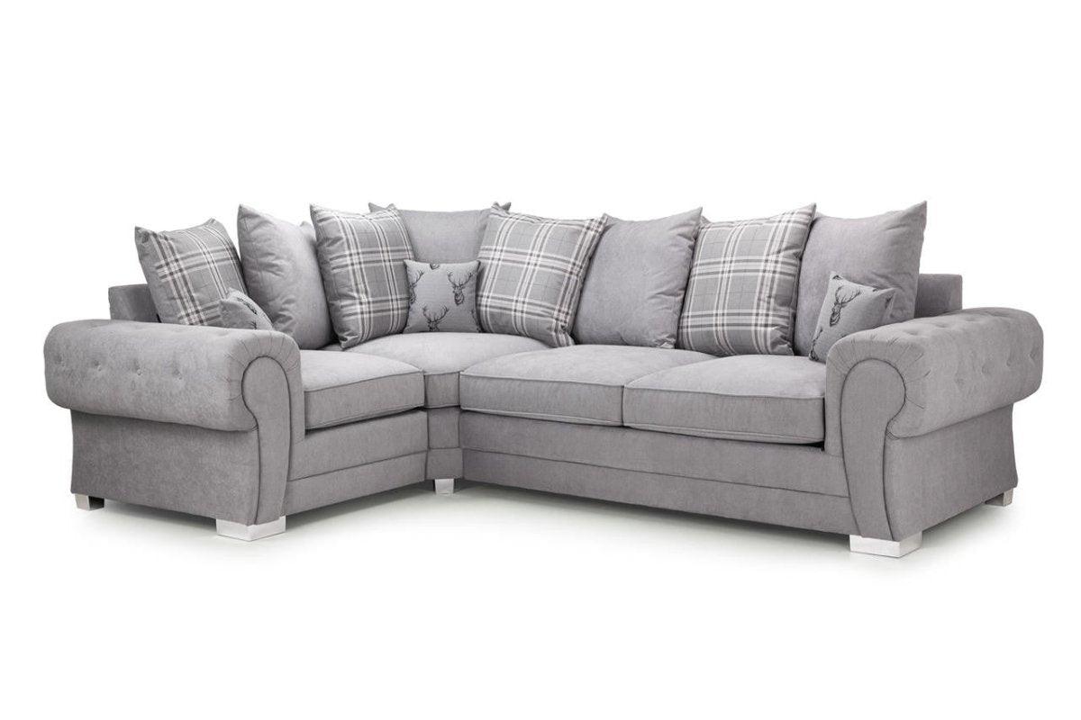 Light grey corner sofa with scatter back cushions and plaid accent pillows